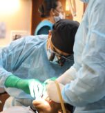 Dentist performing full arch implant training on a live patient