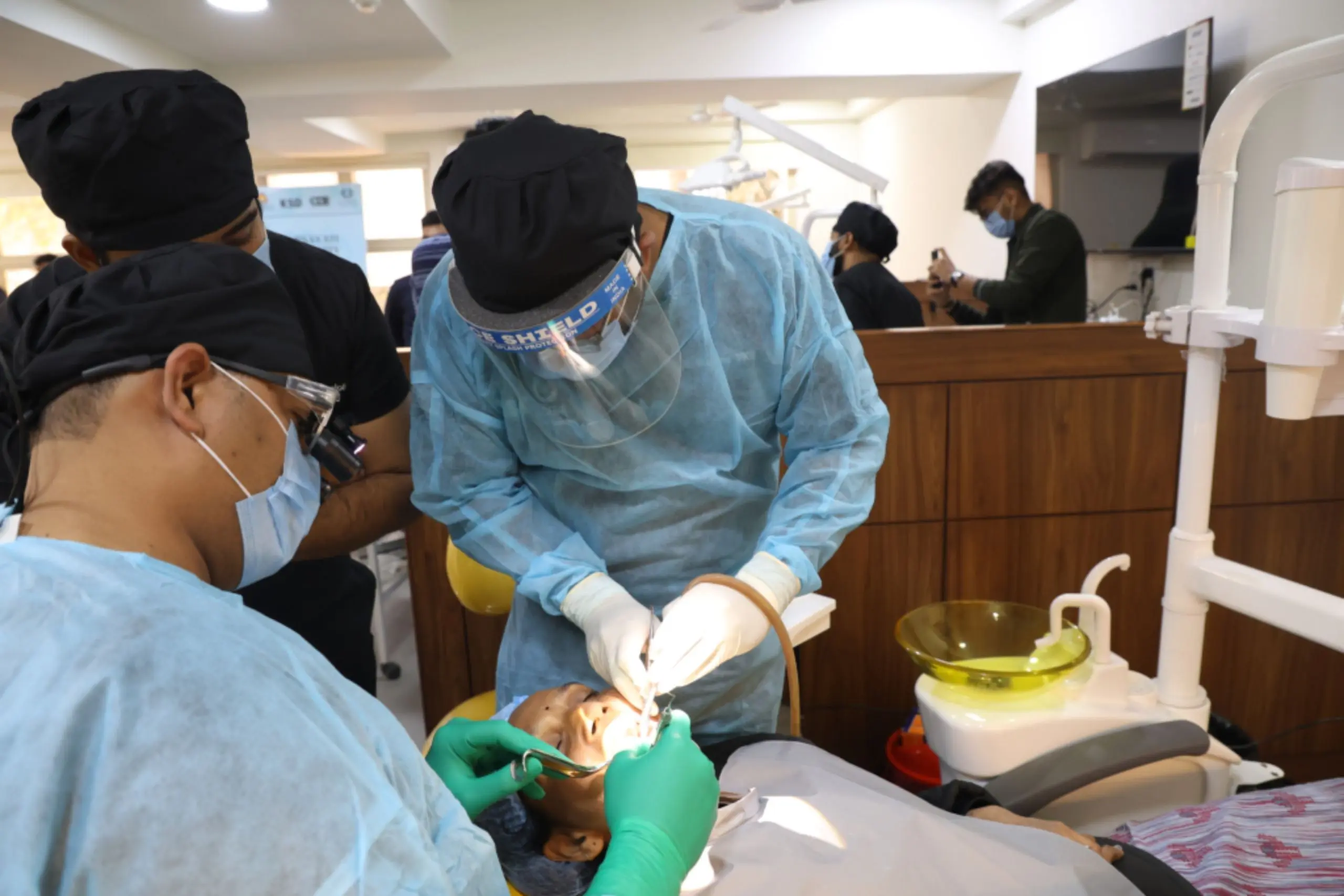 Dentist in a dental implant clinical residency treating a live patient under mentorship